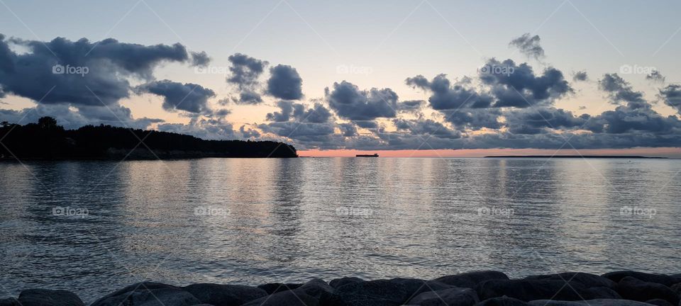 Sunset on the sea, dark clouds