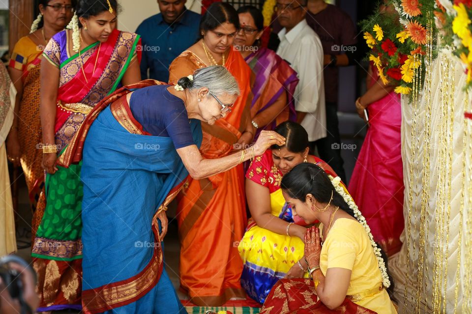 Indian bride getting blessings from elders 
