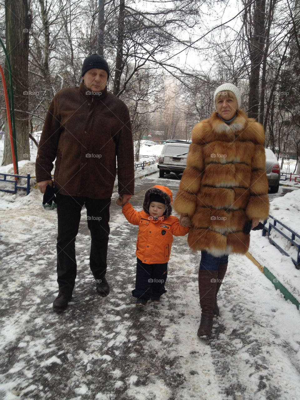 grandmother and grandfather with grandson holding hands