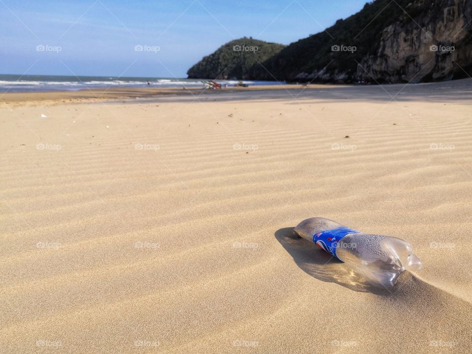 Empty Plastic bottle by the sea