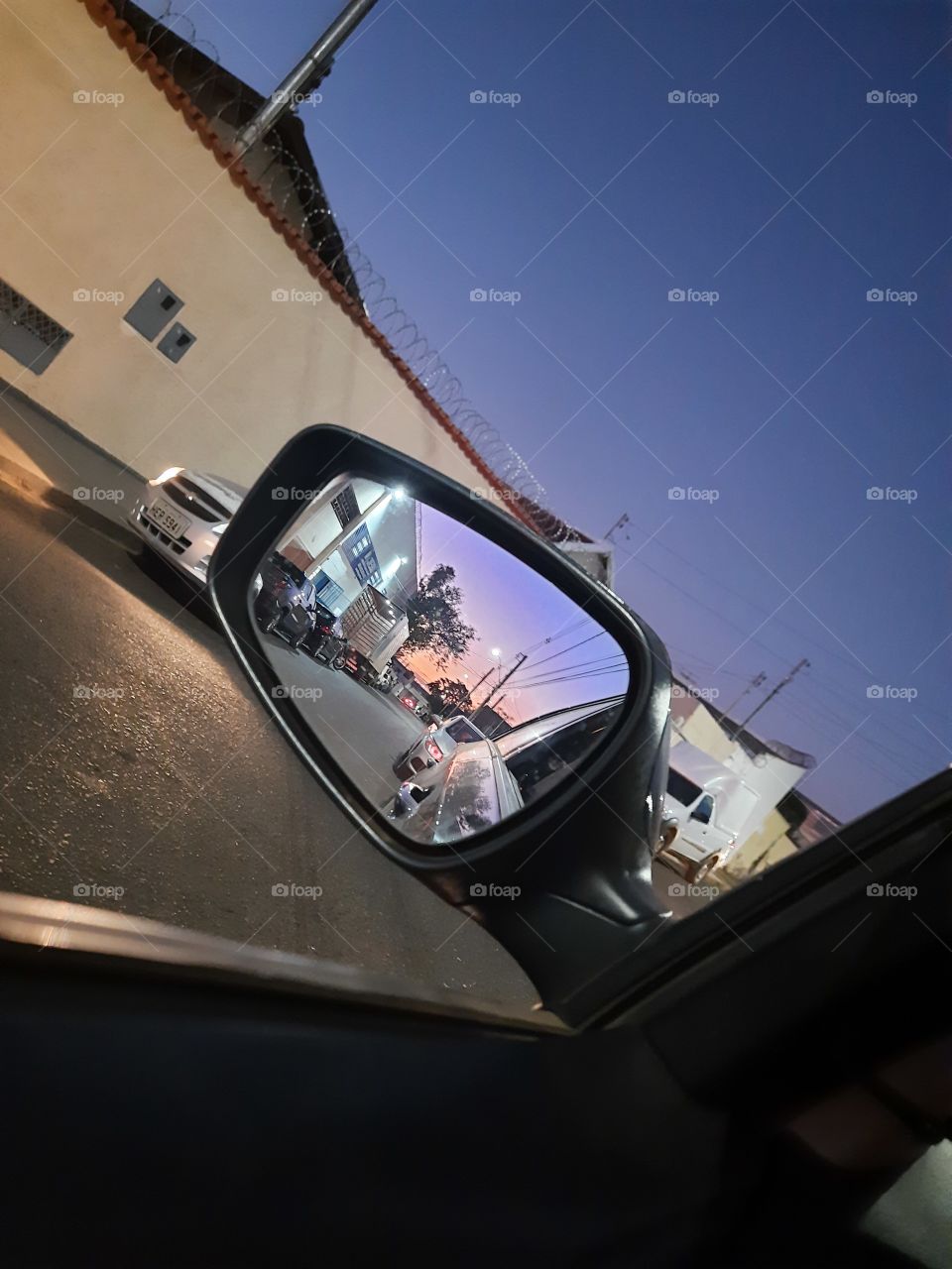 sunset image through car window and car rear view