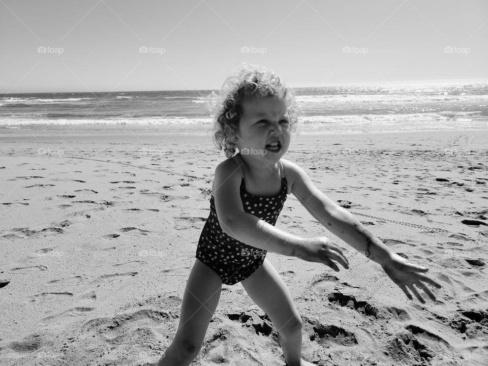 Angry little girl on the beach