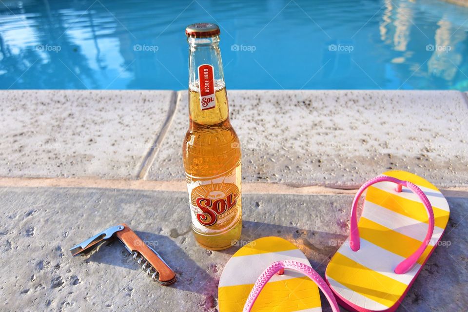 Enjoying cold beer by the pool