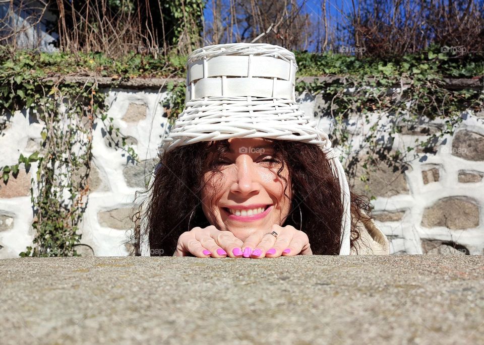 Funny Portrait of Young Woman Posing With Basket on Head, Smiling with Happy Face