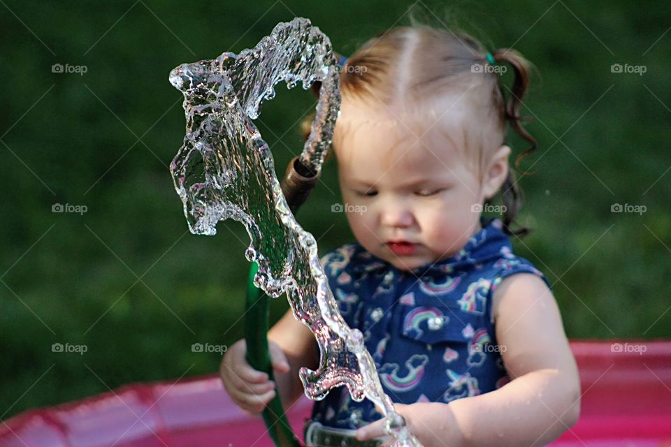 Captured this beautiful photo of little Addy playing with the water hose. This is my favorite picture of the photoshoot by far.  I hope to capture more moments like this soon.