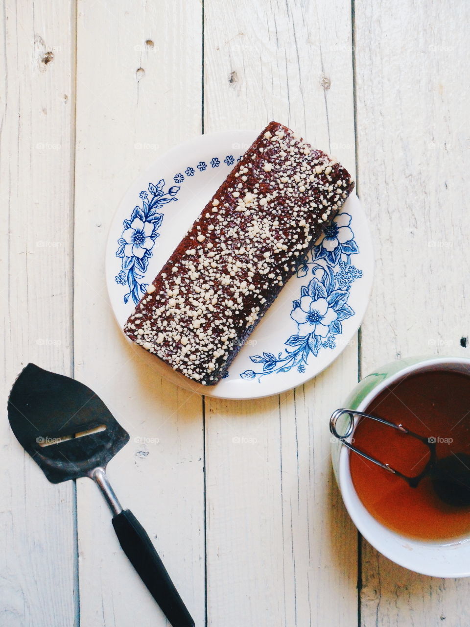 chocolate roll and a cup of black tea on a white background