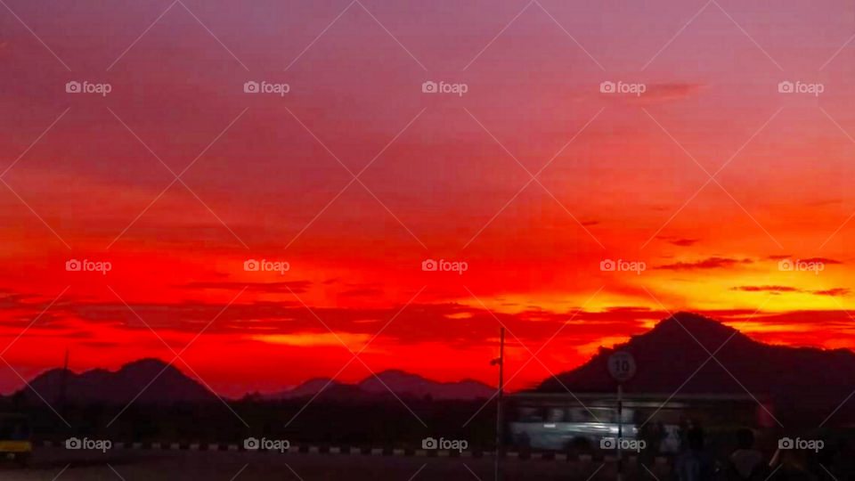 An Eye-catching view of blood-red sky sunset.clouds moving out.Clash of Colors.