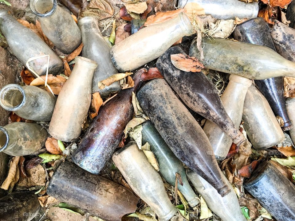 Antique old retro vintage bottles, dug up, muddy, dirty, broken, intact, variety including milk bottles, medicine bottles collectibles