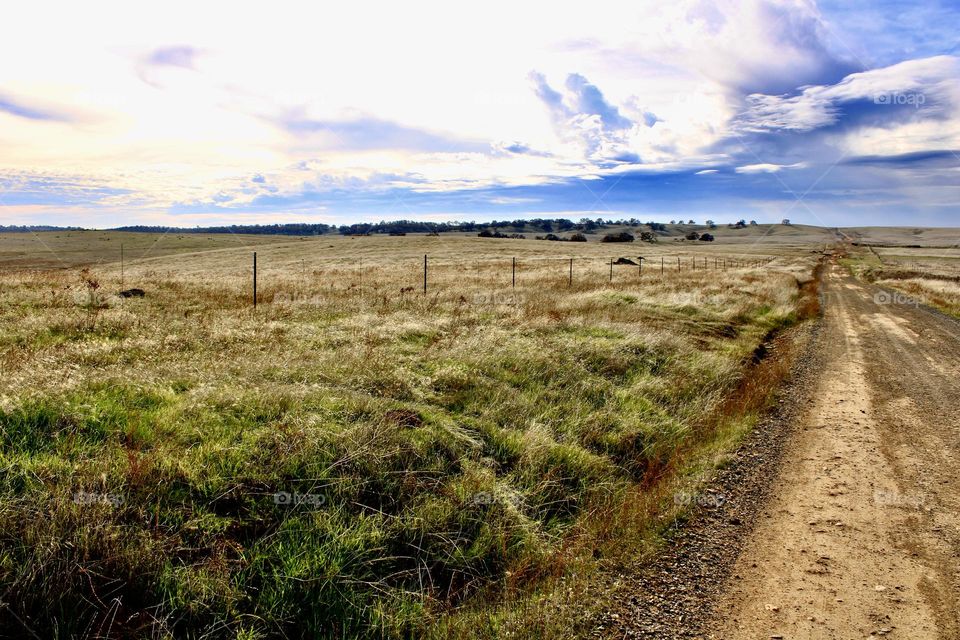 Open country road, destination unknown storm coming in 