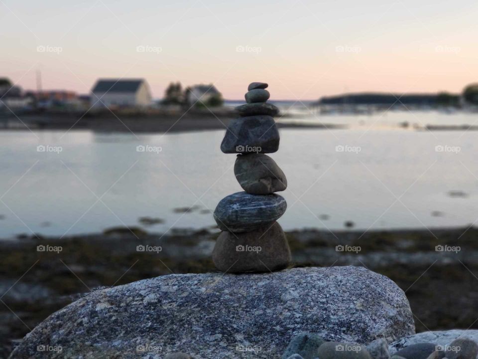 Rock stack near calm water