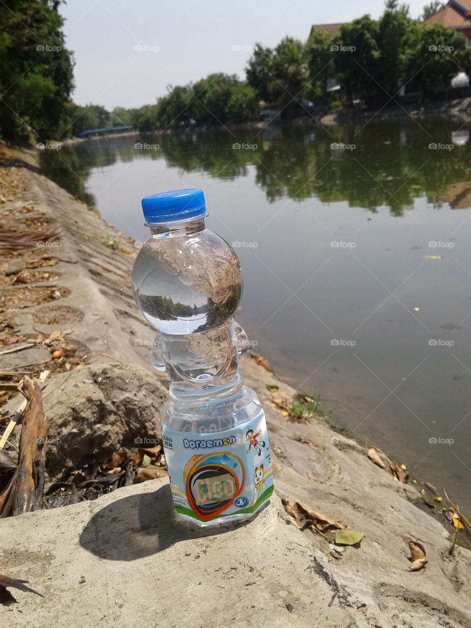 Doraemon bottle water beside the river...