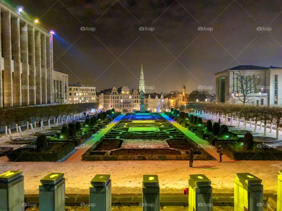 Mont des arts in Brussels, Belgium, as seen at night in januari 2019, with the colorful lights over the garden, and a view over the old city