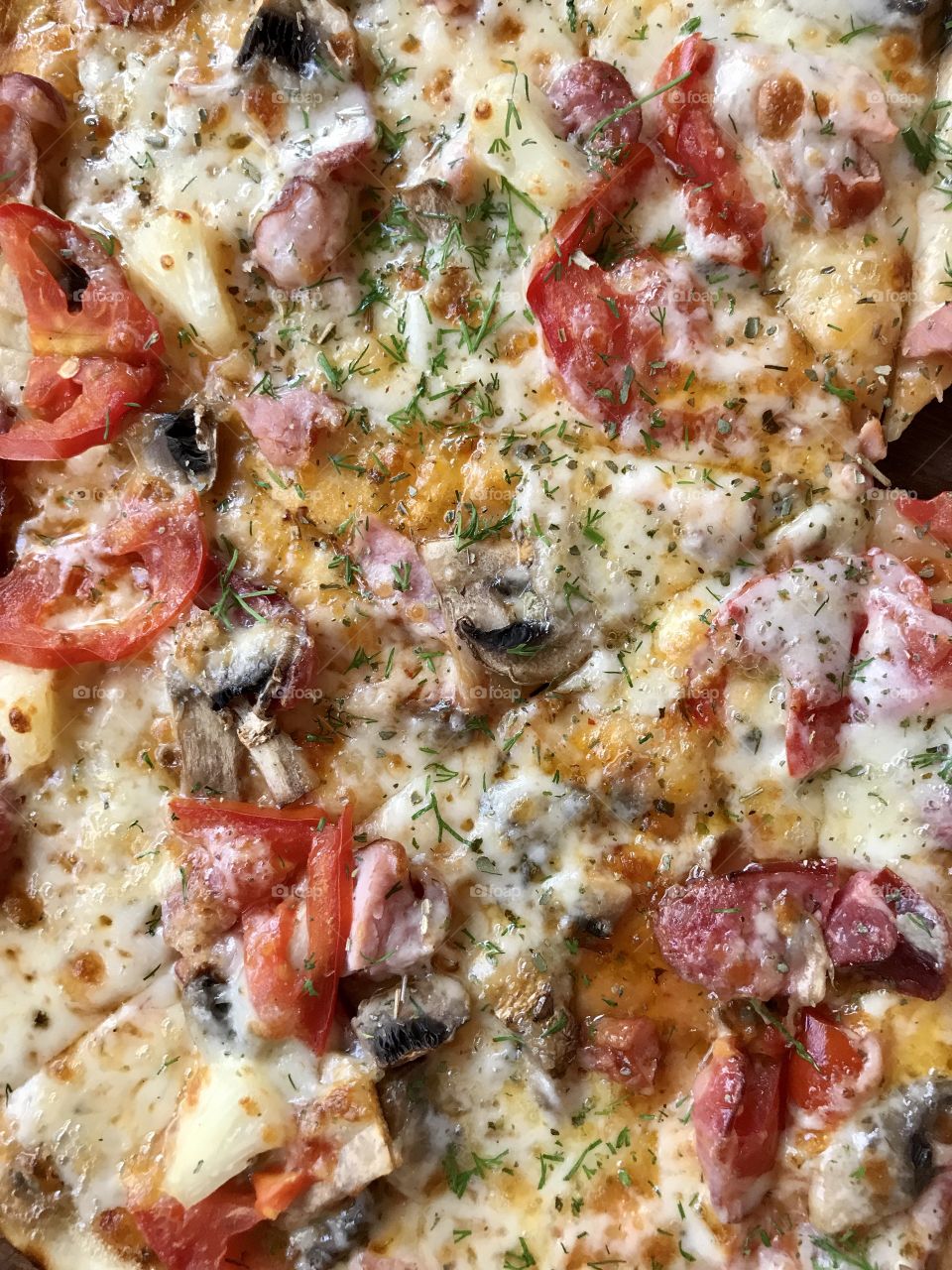 baked delicious crispy pizza with sausages, tomatoes and cheese