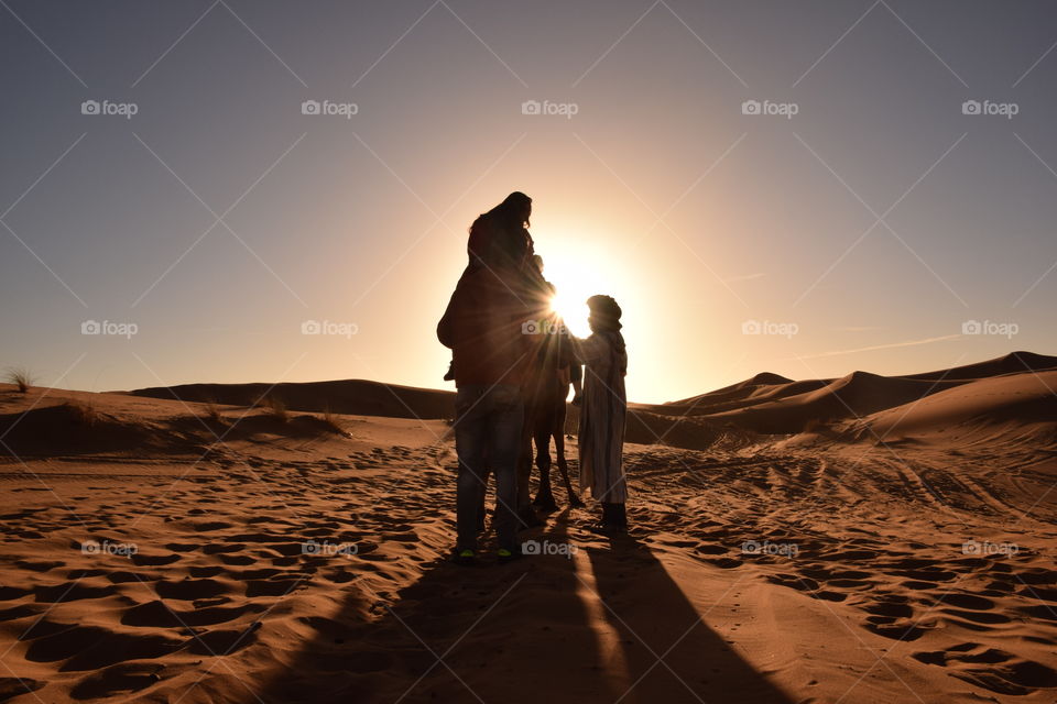 Woman riding on dromedary camel at Sahara desert, Morroco