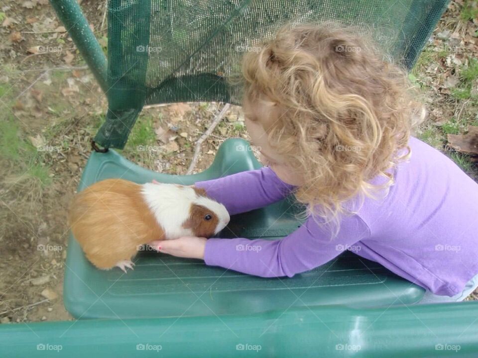 A little girl and her guinea pig. 