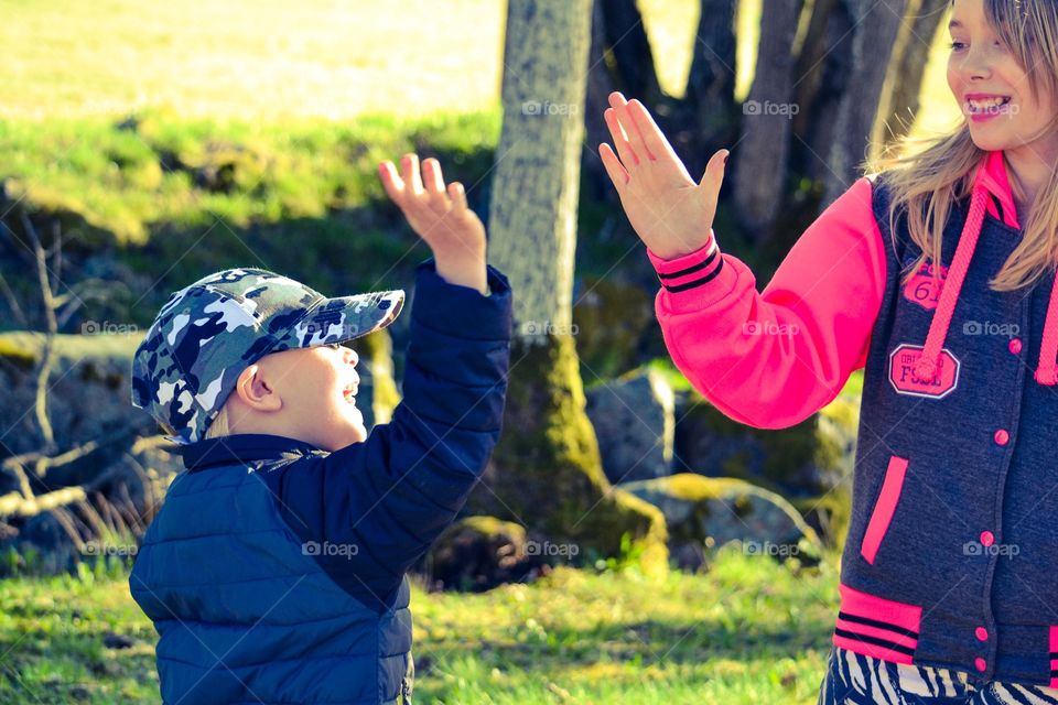 High five. Two siblings having fun