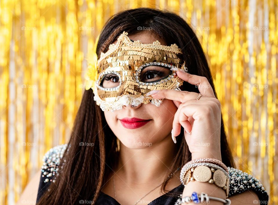 woman wearing golden mask on costume party