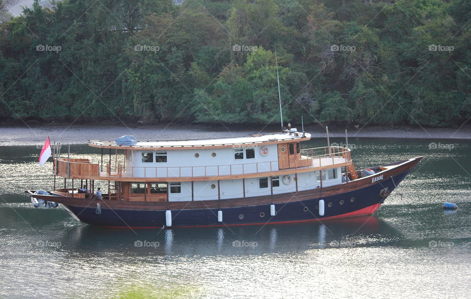 Indonesian flag of tourism wood material ship. Time to rest for the corner site where surround of mangrove until the times's not deal to use .