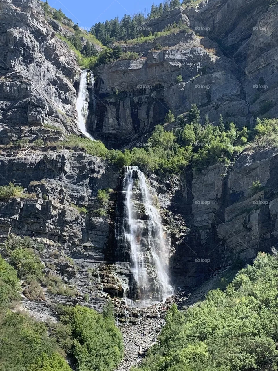 A waterfall in the side of a cliff.
