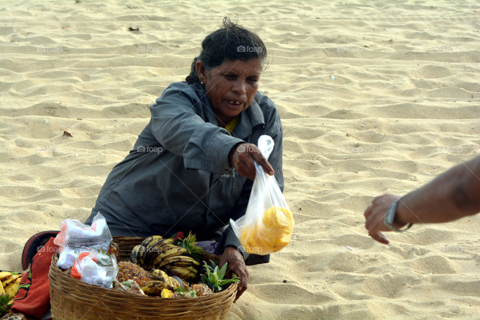 Woman selling fruits on beach