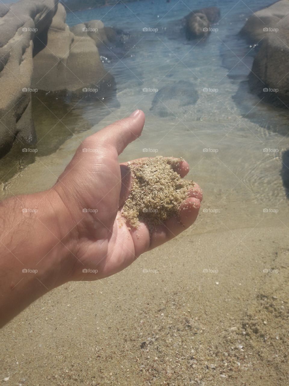 Yellow sand in hand on beach