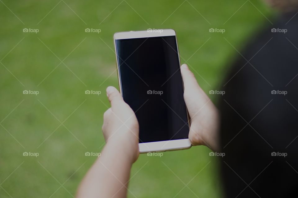 little boy holding a mobile phone