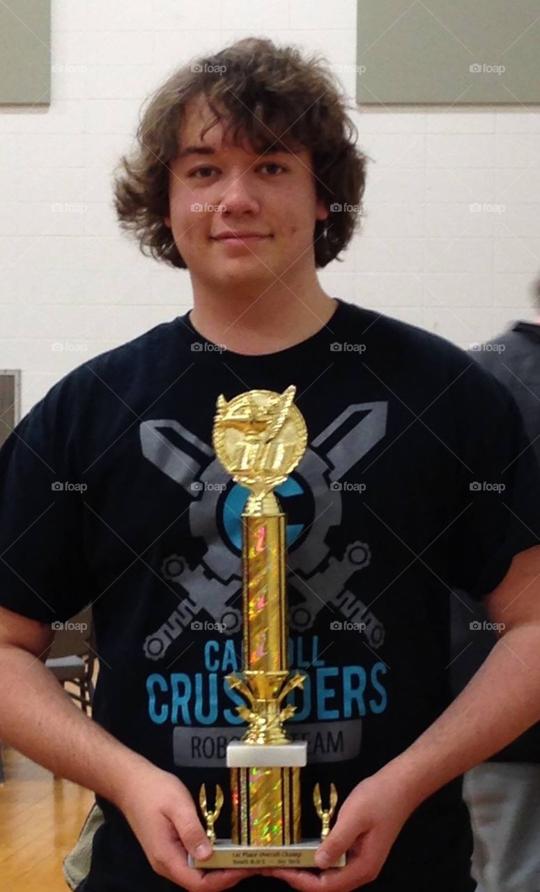 Young man with golden trophy