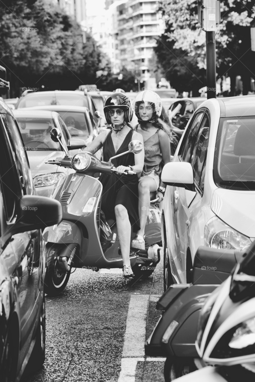 2 girls riding a scooter