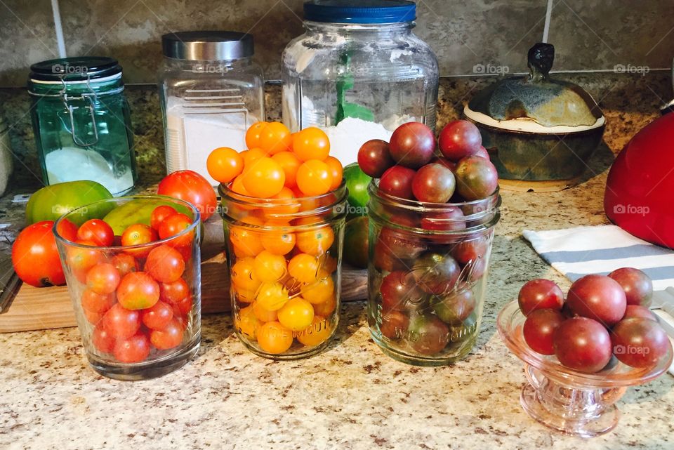 Red, Black, and Sungold cherry tomatoes in glass 
