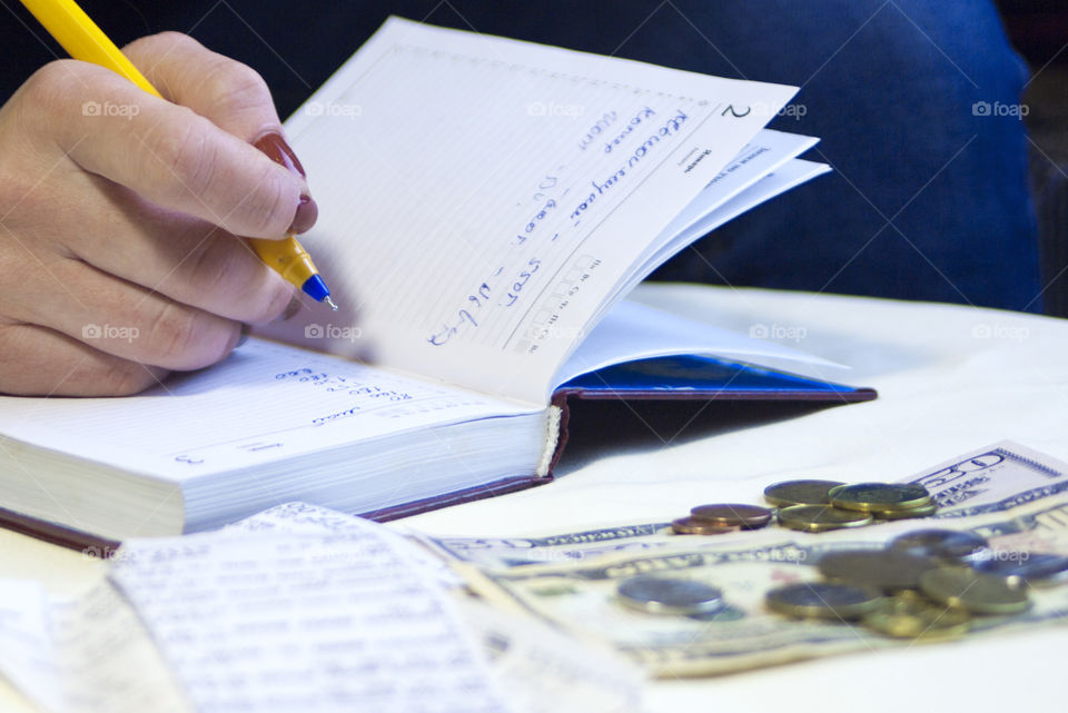 woman takes notes in notepad and says Finance