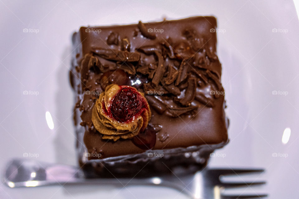 Chocolate mousse with raspberries on a white plate