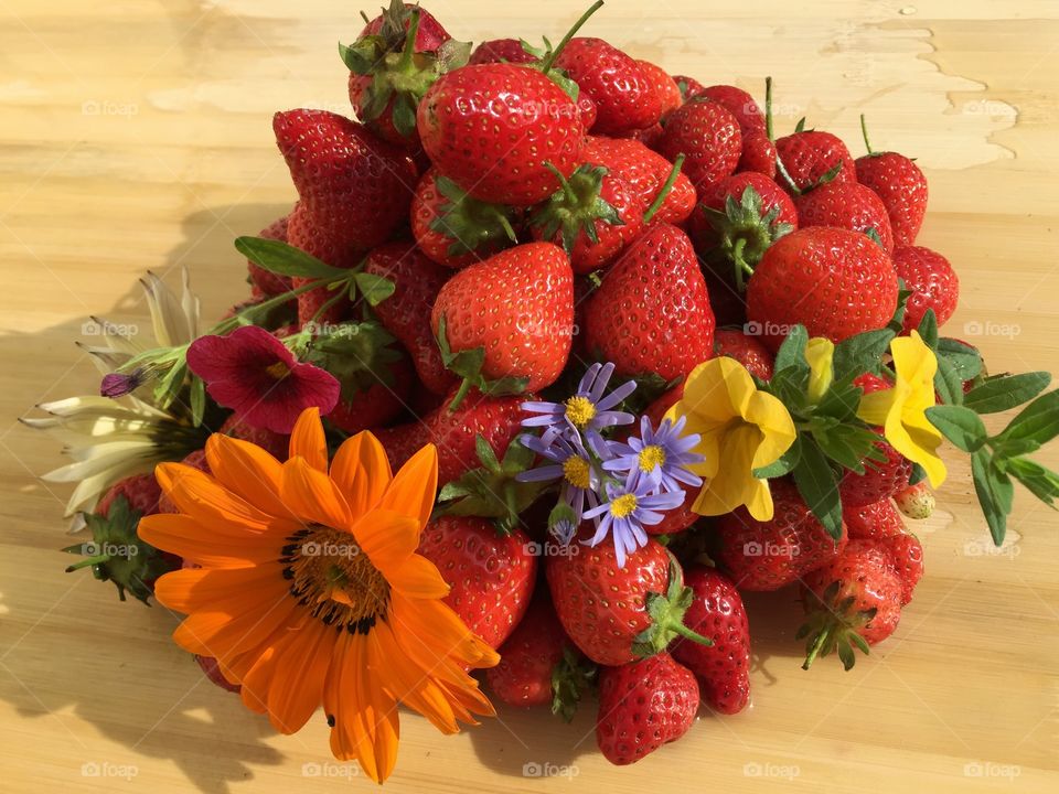 Strawberries and flowers for breakfast . Strawberries and flowers to begin a good day