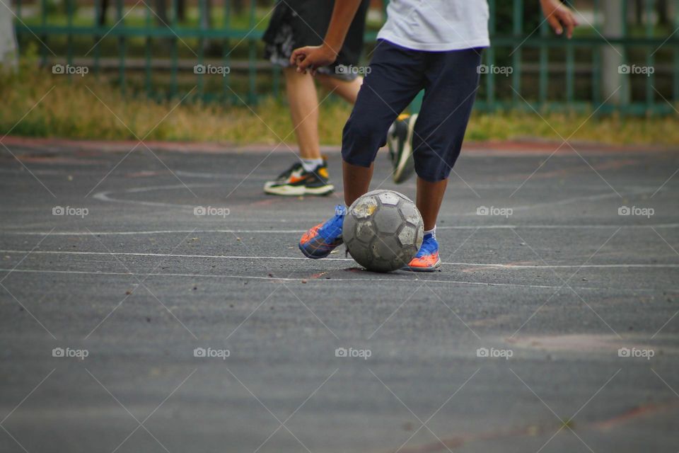 children in the old stadium play football.