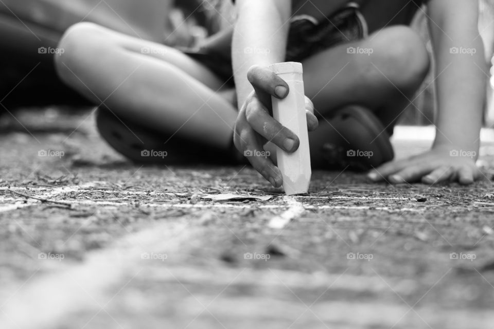 Child drawing with chalk