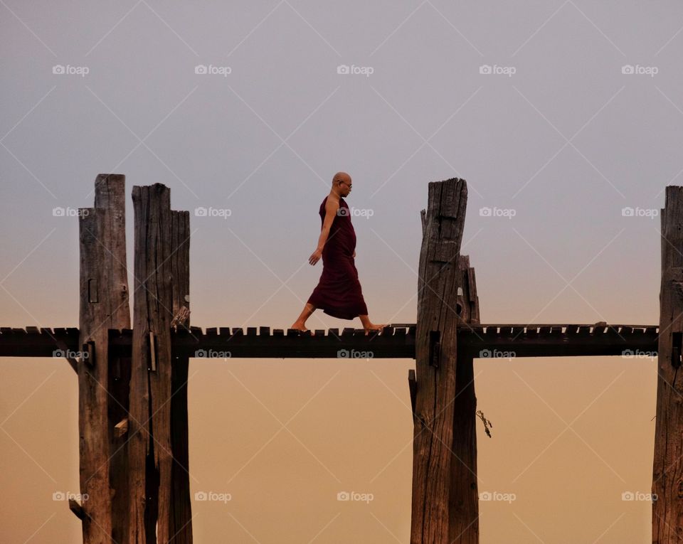 Local monk is walking on U Bein the longest wooden bridge in the world,Mandalay Myanmar 