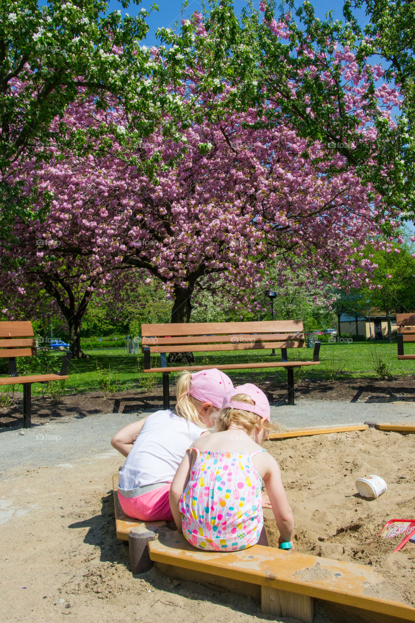 Two young sister is playing at a playground in Malmö Sweden.