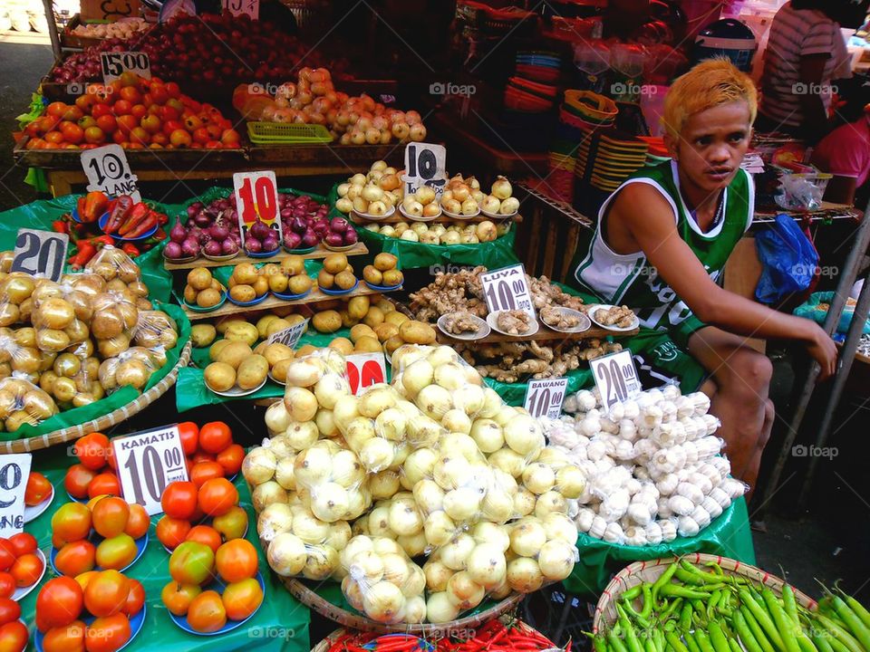 asian street vendor selling fruits and vegetables in quiapo, manila, philippines in asia