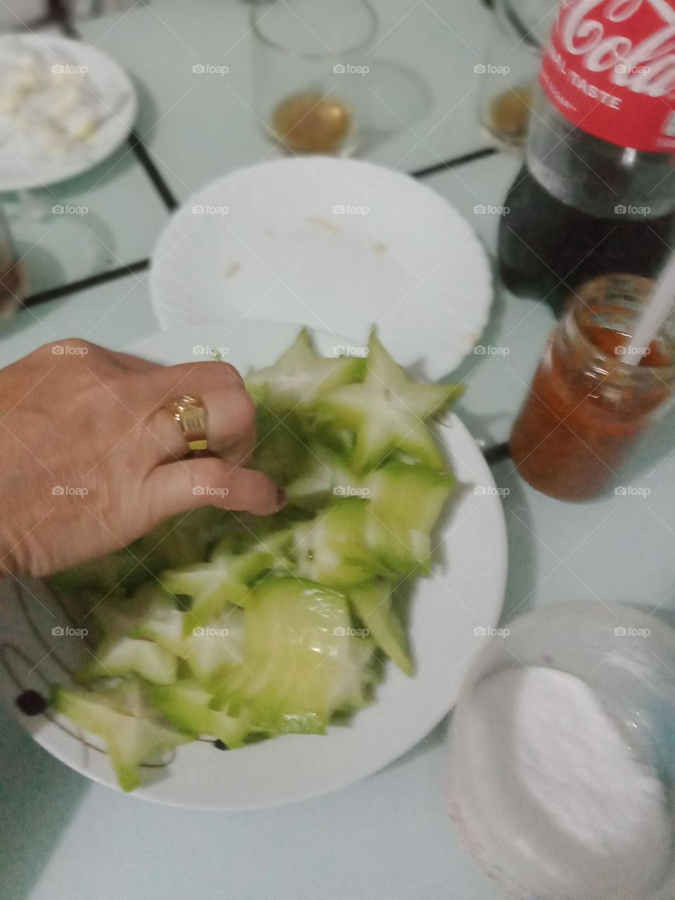 green star apple (balimbing),with rock salt and coke ,ohh someone is picking it,, excuse me, i'm just taking a photo,,