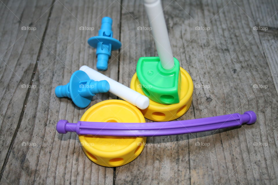 Children’s tinker toys in bright vibrant colors of green, yellow, blue, and purple 