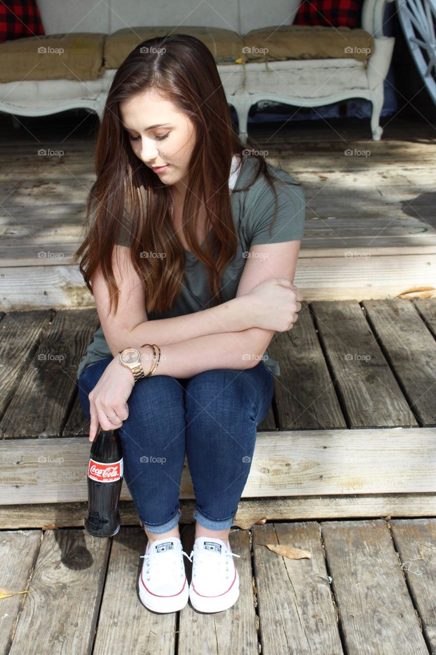 On the steps with a drink