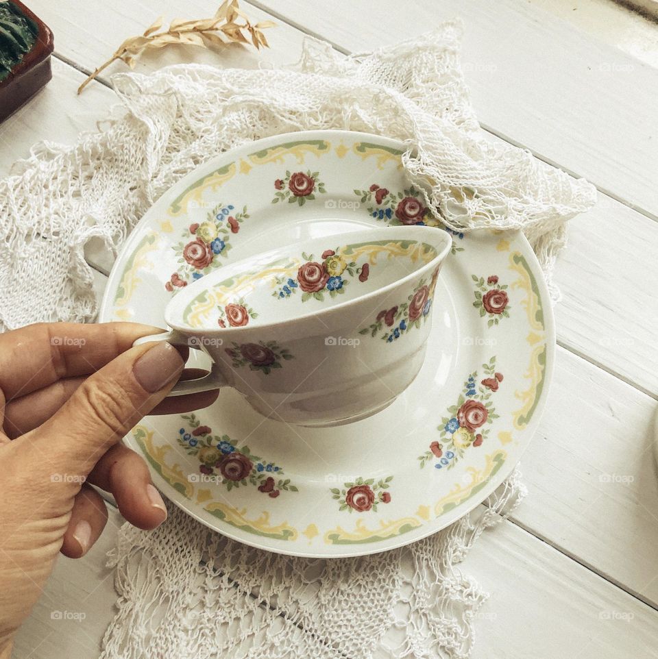 Old porcelain cup and saucer with flower ornament