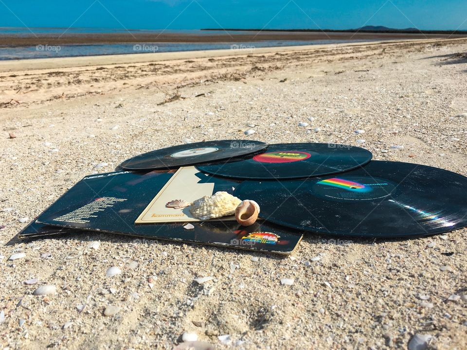 Beach scene vintage vinyl records music outdoors low tide sea coast