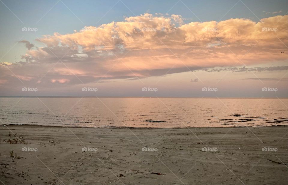 Pink and purple sunset on lake eerie shoreline on Cedar Point’s sandy beach