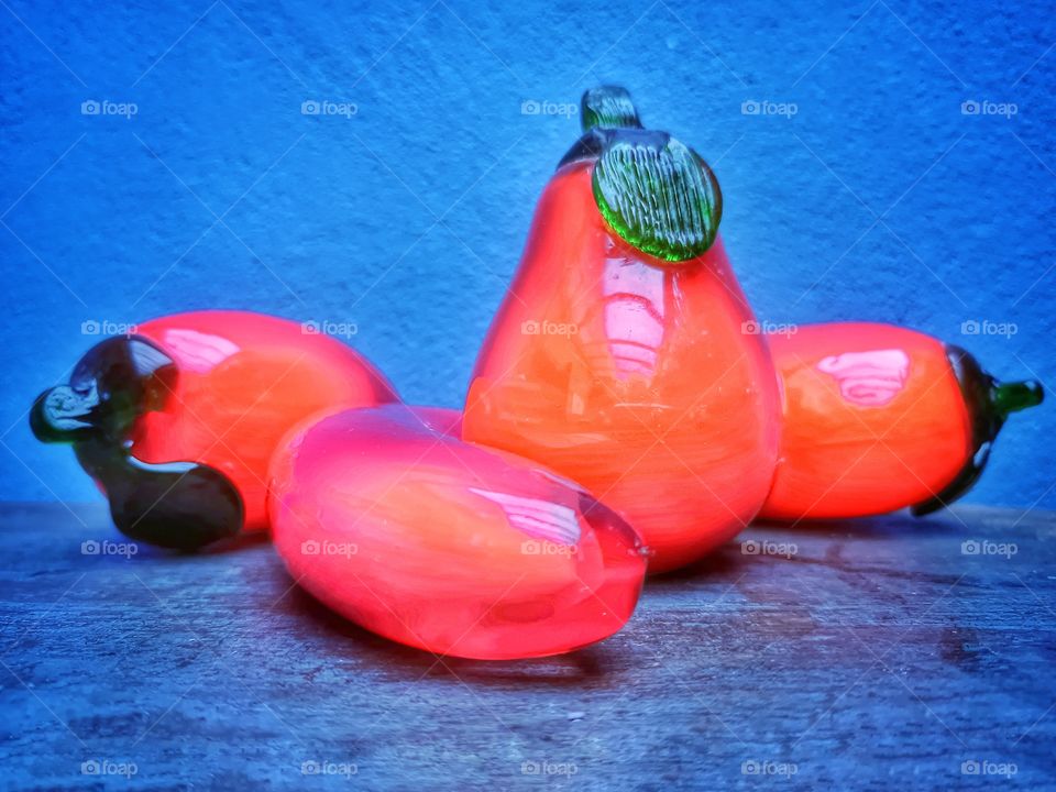 orange glass fruit on the blue wall