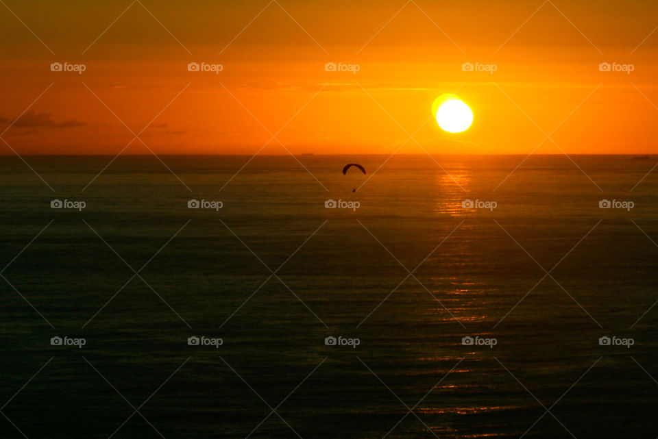 Sunset over the sea with paraglider in the distance. Love the peaceful feel of this image.