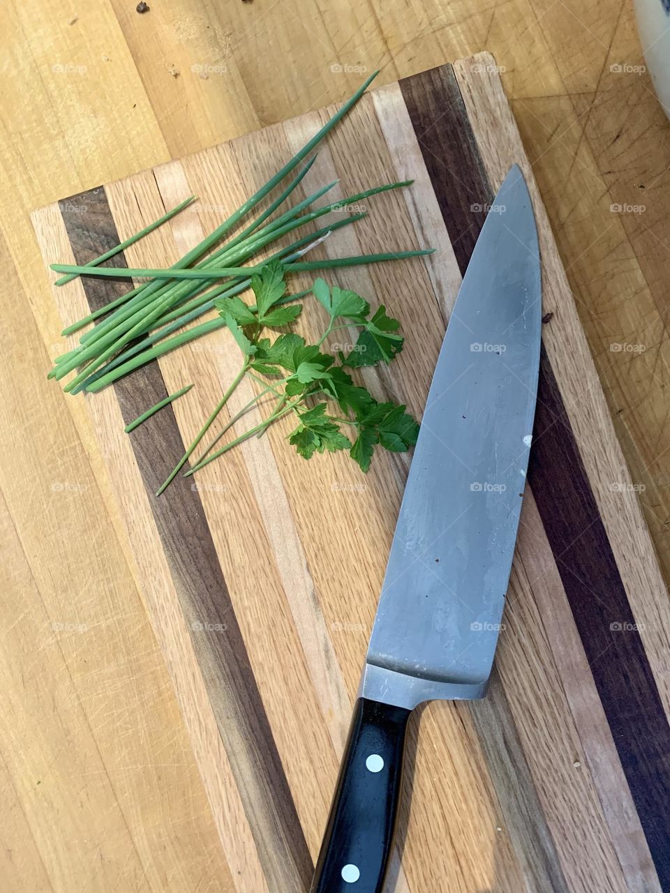 Herbs and knife on cutting board 
