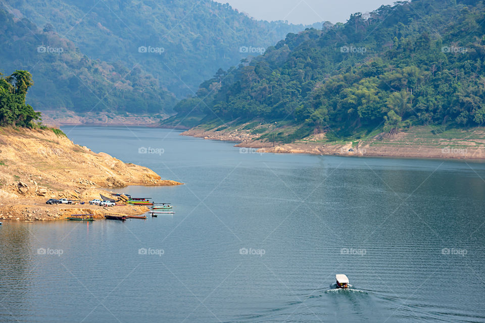 The tourist boat pier park on water at Khun Dan Prakan Chon Dam