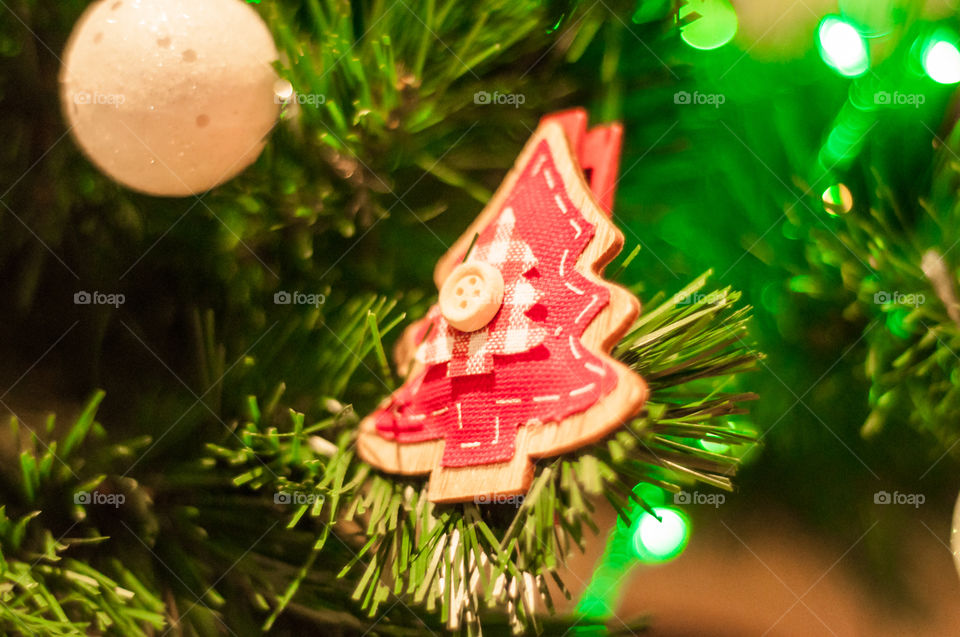 Part of the Christmas tree with red wooden small Christmas tree