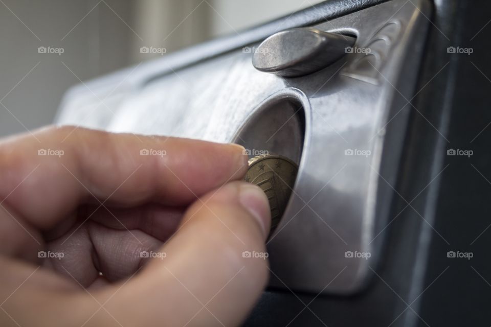 Inserting coin in Pay phone 