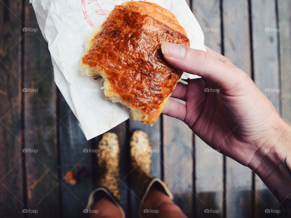Person's hand holding baked puff in hand